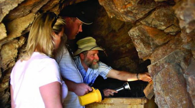 Prospector with guests in Parabonito mine shaft 500 ft deep Prospector with guests in Parabonito mine shaft 500 ft deep